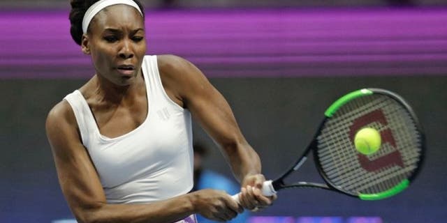Venus Williams of the U.S. returns the ball to Kristina Mladenovic of France during the St. Petersburg Ladies Trophy-2017 tennis tournament match in St. Petersburg, Russia, Thursday, Feb. 2, 2017.