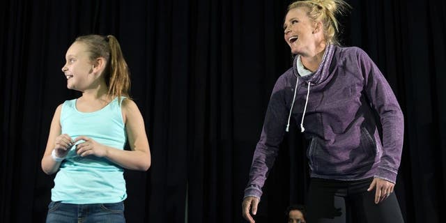 LAS VEGAS, NV - MARCH 2: UFC bantamweight champion Holly Holm brings a fan on stage and holds an open training session for fans and media at the Jabbawockeez Theater in the MGM Grand Hotel/Casino on March 2, 2016 in Las Vegas, Nevada. (Photo by Brandon Magnus/Zuffa LLC/Zuffa LLC via Getty Images)