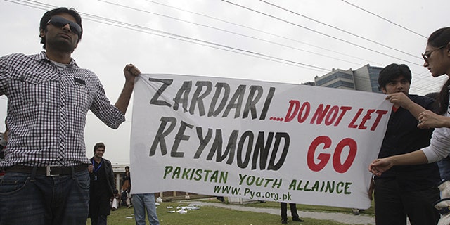 March 3: Pakistani students hold banner in Lahore, Pakistan against American CIA contractor Raymond Allen Davis.