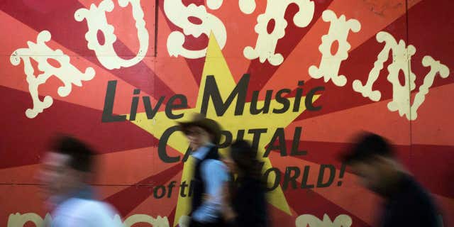 Dec. 19, 2012: Visitors walk past a sign on Sixth Street in Austin, Texas.