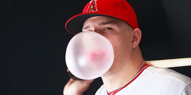 Feb 28, 2015; Tempe, AZ, USA; Los Angeles Angels outfields Mike Trout (27) blows a bubble gum bubble while he poses for a photo during photo day at Tempe Diablo Stadium. Mandatory Credit: Allan Henry-USA TODAY Sports
