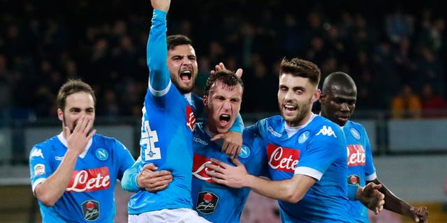 Napoli's Romanian defender Vlad Chiriches (C) celebrates with teammates after scoring a goal during the Italian Serie A football match between SSC Napoli and AC Chievo Verona on March 5, 2016 at the San Paolo stadium in Naples. / AFP / CARLO HERMANN (Photo credit should read CARLO HERMANN/AFP/Getty Images)