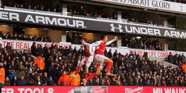 Arsenal's Chilean striker Alexis Sanchez (R) celebrates with Arsenal's Spanish defender Hector Bellerin (L) after scoring their second goal during the English Premier League football match between Tottenham Hotspur and Arsenal at White Hart Lane in London, on March 5, 2016. / AFP / ADRIAN DENNIS / RESTRICTED TO EDITORIAL USE. No use with unauthorized audio, video, data, fixture lists, club/league logos or 'live' services. Online in-match use limited to 75 images, no video emulation. No use in betting, games or single club/league/player publications. / (Photo credit should read ADRIAN DENNIS/AFP/Getty Images)