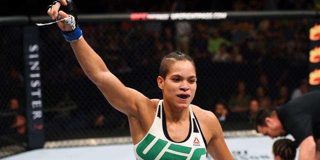 NASHVILLE, TN - AUGUST 08: (L-R) Amanda Nunes of Brazil celebrates after defeating Sara McMann in their women's bantamweight bout during the UFC Fight Night event at Bridgestone Arena on August 8, 2015 in Nashville, Tennessee. (Photo by Josh Hedges/Zuffa LLC/Zuffa LLC via Getty Images)