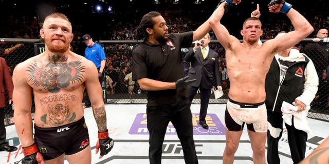 LAS VEGAS, NV - MARCH 05: Nate Diaz (right) reacts to his victory over Conor McGregor of Ireland (left) in their welterweight bout during the UFC 196 event inside MGM Grand Garden Arena on March 5, 2016 in Las Vegas, Nevada. (Photo by Josh Hedges/Zuffa LLC/Zuffa LLC via Getty Images)