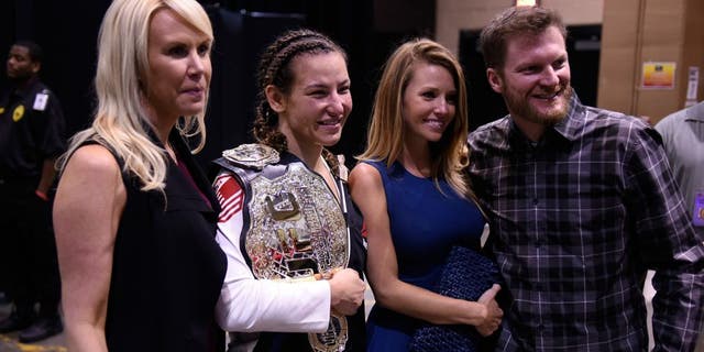 LAS VEGAS, NV - MARCH 05: (L-R) DeLana Harvick, Miesha Tate, Amy Reimann and NASCAR driver Dale Earnhardt, Jr. backstage during the UFC 196 event inside MGM Grand Garden Arena on March 5, 2016 in Las Vegas, Nevada. (Photo by Todd Lussier/Zuffa LLC/Zuffa LLC via Getty Images)