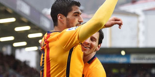Barcelona's Uruguayan forward Luis Suarez (L) is congratulated by Argentinian forward Lionel Messi after scoring during the Spanish league football match SD Eibar vs FC Barcelona at the Ipurua stadium in Eibar on March 6, 2016. / AFP / ANDER GILLENEA (Photo credit should read ANDER GILLENEA/AFP/Getty Images)