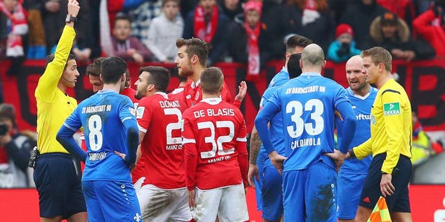 MAINZ, GERMANY - MARCH 06: Referee Benjamin Brand shows the red card to Giulio Donati of Mainz during the Bundesliga match between 1. FSV Mainz 05 and SV Darmstadt 98 at Coface Arena on March 6, 2016 in Mainz, Germany. (Photo by Alex Grimm/Bongarts/Getty Images)