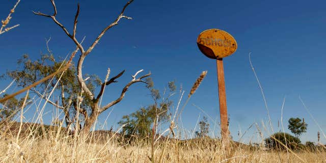 A rusting sign indicating where a school once operated stands in the former town of Wittenoom, about 870 miles north of the West Australian city of Perth.