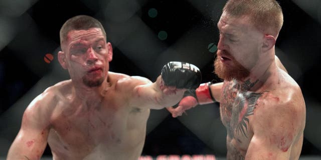 LAS VEGAS, NV - MARCH 5: (L-R) Nate Diaz punches Conor McGregor in their welterweight bout during the UFC 196 in the MGM Grand Garden Arena on March 5, 2016 in Las Vegas, Nevada. (Photo by Brandon Magnus/Zuffa LLC/Zuffa LLC via Getty Images)