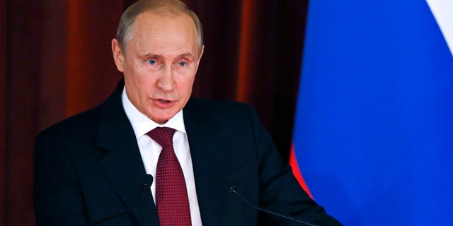 Russian President Vladimir Putin delivers a speech during a meeting with Russian ambassadors, envoys and diplomats at the Foreign Ministry headquarters in Moscow, Tuesday, July 1, 2014. (AP Photo//Maxim Zmeyev, Pool)