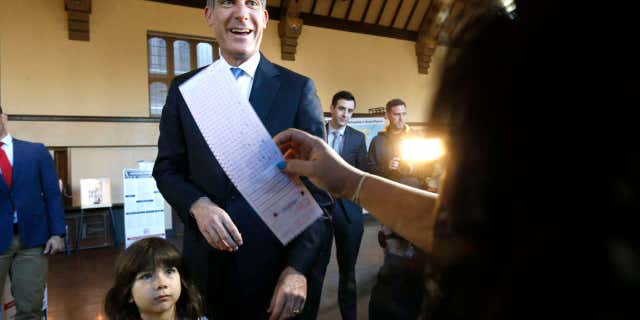 Los Angeles Mayor Eric Garcetti casts his election ballot with his daughter Maya in Los Angeles, on Tuesday, March 7, 2017.