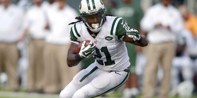 Sep 7, 2014; East Rutherford, NJ, USA; New York Jets running back Chris Johnson (21) carries the ball against the Oakland Raiders at MetLife Stadium. Mandatory Credit: Kirby Lee-USA TODAY Sports