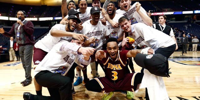 Mar 7, 2016; Albany, NY, USA; Iona Gaels guard Ibn Muhammad (3) and the rest of the team celebrate after defeating the Monmouth Hawks in the MAAC conference tournament finals at Times Union Center. Mandatory Credit: Mark L. Baer-USA TODAY Sports