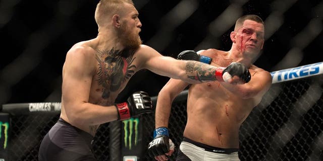 LAS VEGAS, NV - MARCH 5: (L-R) Conor McGregor punches Nate Diaz in their welterweight bout during the UFC 196 in the MGM Grand Garden Arena on March 5, 2016 in Las Vegas, Nevada. (Photo by Brandon Magnus/Zuffa LLC/Zuffa LLC via Getty Images)