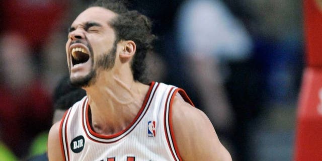 Chicago Bulls Joakim Noah reacts after being fouled by Miami Heat's Greg Oden during the first half of an NBA basketball game in Chicago, Sunday, March 9, 2014. (AP Photo/ Paul Beaty)
