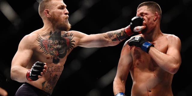 LAS VEGAS, NV - MARCH 05: (L-R) Conor McGregor of Ireland punches Nate Diaz during the UFC 196 event inside MGM Grand Garden Arena on March 5, 2016 in Las Vegas, Nevada. (Photo by Jeff Bottari/Zuffa LLC/Zuffa LLC via Getty Images)