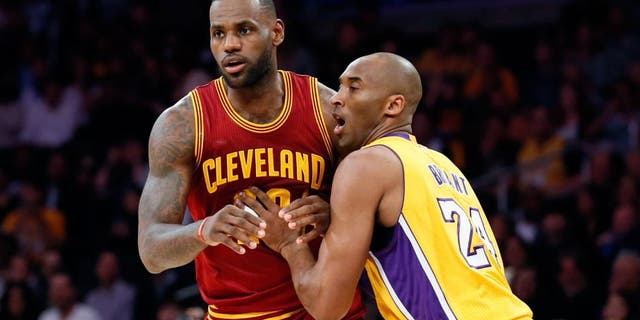 Cleveland Cavaliers' LeBron James, left, moves into position while Los Angeles Lakers' Kobe Bryant, right, defends during the first half of an NBA basketball game Thursday, March 10, 2016, in Los Angeles. (AP Photo/Danny Moloshok)