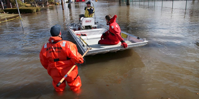 March 12: Paterson, N.J., firefighters make their way onto Totowa Avenue to evacuate residents that need assistance in Paterson, N.J.
