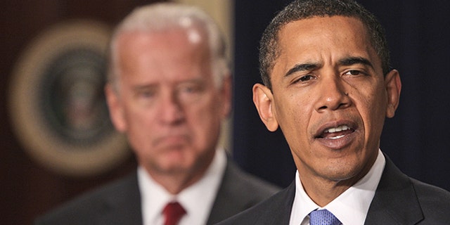 In this Jan. 21, 2009 file photo, President Barack Obama, accompanied by Vice President Joe Biden speaks in the Eisenhower Executive Office Building in Washington.