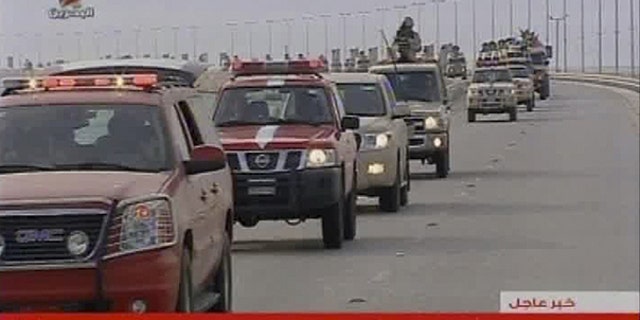 March 14: This screen grab taken from Bahrain TV shows troops arriving in Bahrain from Saudi Arabia.