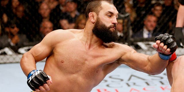 LAS VEGAS, NV - NOVEMBER 16: (L-R) Johny Hendricks punches Georges St-Pierre in their UFC welterweight championship bout during the UFC 167 event inside the MGM Grand Garden Arena on November 16, 2013 in Las Vegas, Nevada. (Photo by Josh Hedges/Zuffa LLC/Zuffa LLC via Getty Images)