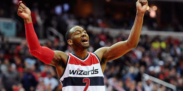 Mar 14, 2015; Washington, DC, USA; Washington Wizards guard John Wall (2) celebrates against the Sacramento Kings during the fourth quarter at Verizon Center. Mandatory Credit: Brad Mills-USA TODAY Sports