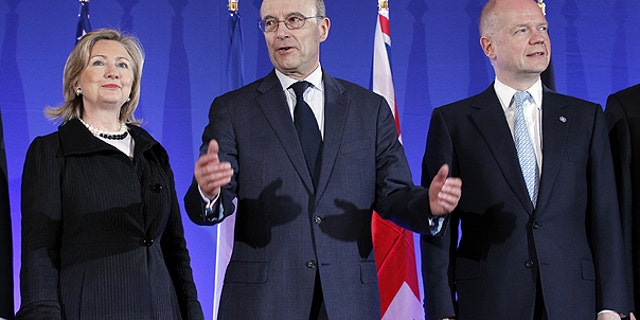 March 14: French Foreign Minister Alain Juppe, center, gestures as he poses with his counterpart William Hague of Britain and U.S. Secretary of State Hillary Rodham Clinton, during a Group of Eight foreign Ministers meeting in Paris.