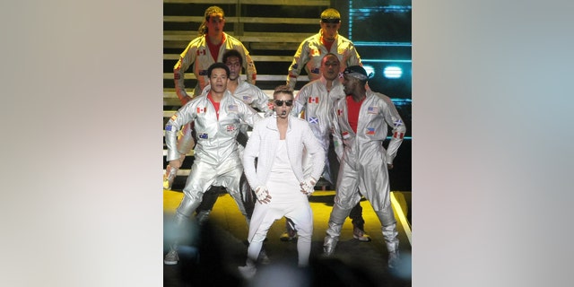 Canada's pop star Justin Bieber performs in concert during his Believe world tour in Buenos Aires, Argentina, Sunday, Nov. 10, 2013. Bieber's manager says food poisoning made him quit the stage during the concert, drawing boos from a huge crowd in River Plate stadium. (AP Photo/Pablo Molina, DyN)