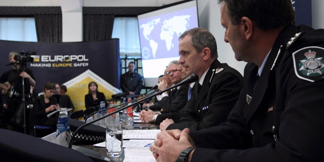 March 16: From left, Grant Edwards, Australian Federal Police, and Peter Davies, of the UK Child Exploitation and Online Protection Center, elaborate on the details of arrests linked to a global child abuse ring during a press conference in The Hague.