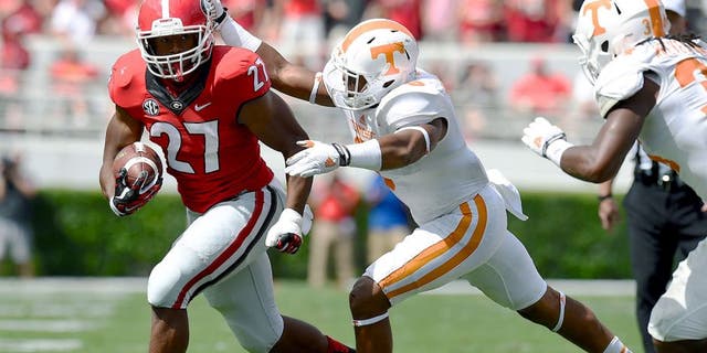 Sep 27, 2014; Athens, GA, USA; Georgia Bulldogs running back Nick Chubb (27) runs against Tennessee Volunteers defensive back Todd Kelly Jr. (6) during the first half at Sanford Stadium. Mandatory Credit: Dale Zanine-USA TODAY Sports
