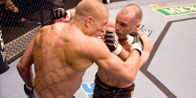 HOUSTON - APRIL 7: Matt Serra (brown/camo shorts) def. Georges St-Pierre (green shorts) - TKO - 3:25 round 1 during UFC 69 at Toyota Center on April 7, 2007 in Houston, Texas. (Photo by Josh Hedges/Zuffa LLC via Getty Images)