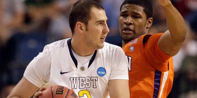 March 17: Clemson's Devin Booker (31) defends as West Virginia's Cam Thoroughman (2) attempts to pass during an East regional second round NCAA tournament college basketball game in Tampa, Fla.