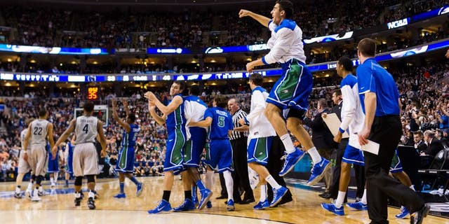 Mar 22, 2013; Philadelphia, PA, USA; Florida Gulf Coast Eagles players celebrate ;ate in the second half against the Georgetown Hoyas during the second round of the 2013 NCAA tournament at the Wells Fargo Center. Florida Gulf Coast defeated Georgetown 78-68. Mandatory Credit: Howard Smith-USA TODAY Sports