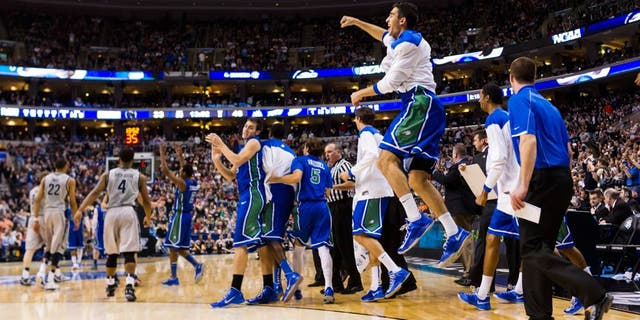 Mar 22, 2013; Philadelphia, PA, USA; Florida Gulf Coast Eagles players celebrate ;ate in the second half against the Georgetown Hoyas during the second round of the 2013 NCAA tournament at the Wells Fargo Center. Florida Gulf Coast defeated Georgetown 78-68. Mandatory Credit: Howard Smith-USA TODAY Sports