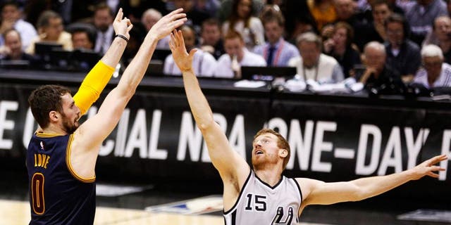 Mar 12, 2015; San Antonio, TX, USA; Cleveland Cavaliers forward Kevin Love (0) shoots the ball over San Antonio Spurs power forward Matt Bonner (15) during the first half at AT&T Center. Mandatory Credit: Soobum Im-USA TODAY Sports