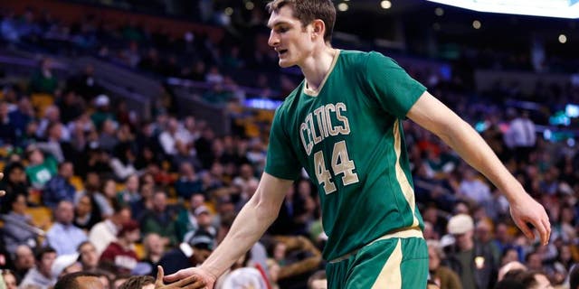 Mar 16, 2015; Boston, MA, USA; Boston Celtics guard Avery Bradley (0) welcomes forward center Tyler Zeller (44) to the bench during the fourth quarter against the Philadelphia 76ers at TD Garden. The Boston Celtics won 108-89. Mandatory Credit: Greg M. Cooper-USA TODAY Sports
