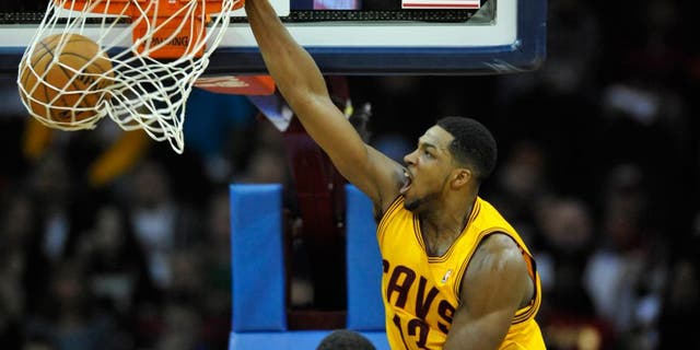 Mar 18, 2014; Cleveland, OH, USA; Cleveland Cavaliers forward Tristan Thompson (13) dunks against the Miami Heat in the first quarter at Quicken Loans Arena. Mandatory Credit: David Richard-USA TODAY Sports