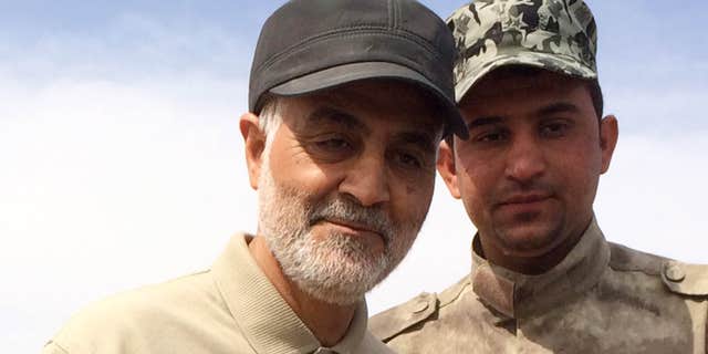 March 8, 2015: Iranian Revolutionary Guard Commander Qassem Soleimani (L) stands at the frontline during offensive operations against Islamic State militants in the town of Tal Ksaiba in Salahuddin province.