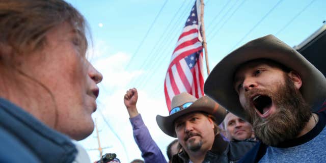 March 18, 2016: A protester confronts supporters of Republican presidential candidate Donald Trump in downtown Salt Lake City as Donald Trump gave his first campaign speech in Utah.