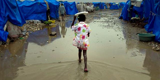 March 19: A girl walks at a homeless earthquake survivors camp during heavy rains in Port-au-Prince, Haiti.