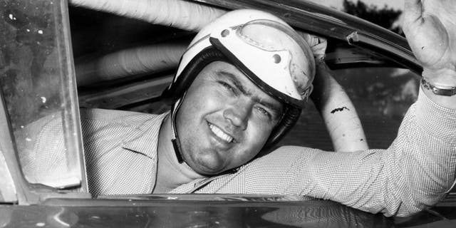 Junior Johnson looks out his car window before a race in 1959. (RacingOne/Getty Images)