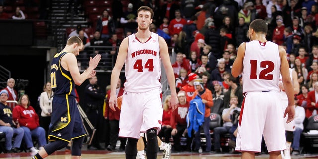 Wisconsin's Frank Kaminsky (44) and Traevon Jackson (12) walk off the court after the team's 77-70 loss to Michigan in an NCAA college basketball game Saturday, Jan. 18, 2014, in Madison, Wis.  (AP Photo/Andy Manis)
