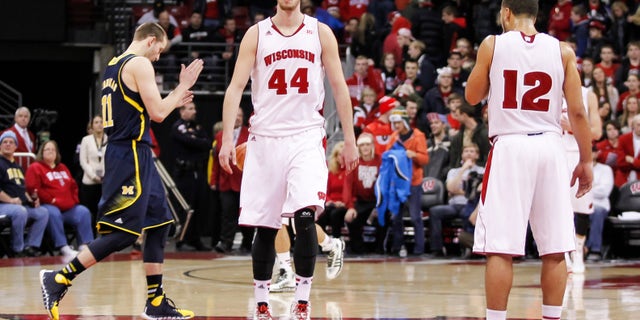 Wisconsin's Frank Kaminsky (44) and Traevon Jackson (12) walk off the court after the team's 77-70 loss to Michigan in an NCAA college basketball game Saturday, Jan. 18, 2014, in Madison, Wis. (AP Photo/Andy Manis)