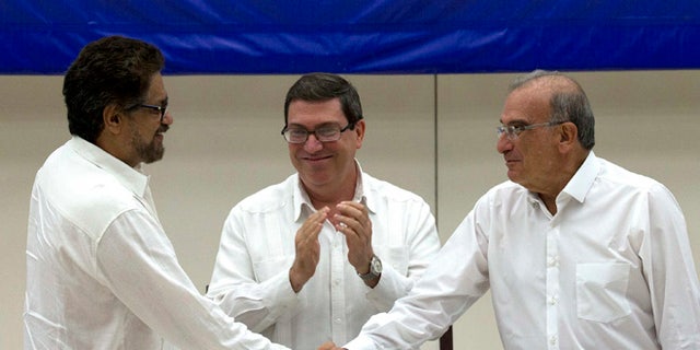 Humberto de La Calle, Ivan Marquez and Cuban Foreign Minister Bruno Rodriguez after signing an agreement in Havana, Cuba.