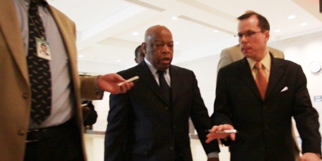 Rep. John Lewis, D-Ga., is questioned by reporters about an incident involving Tea Party demonstrators as he leaves a speech by President Obama to House Democrats on Saturday, March 20, 2010. (AP)