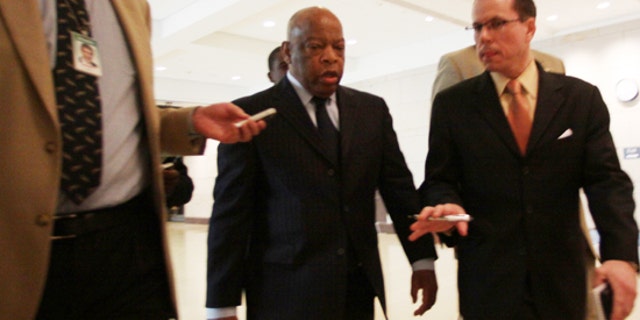 Rep. John Lewis, D-Ga., is questioned by reporters about an incident involving Tea Party demonstrators as he leaves a speech by President Obama to House Democrats on Saturday, March 20, 2010. (AP)