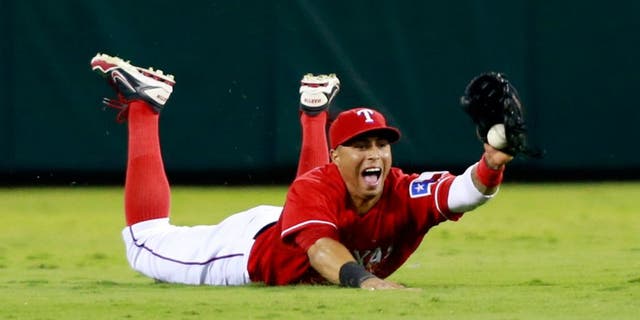 Sep 30, 2013; Arlington, TX, USA; Texas Rangers center fielder Leonys Martin catches a ball hit by Tampa Bay Rays designated hitter Delmon Young (not pictured) during the seventh inning at Rangers Ballpark at Arlington. Mandatory Credit: Tim Heitman-USA TODAY Sports