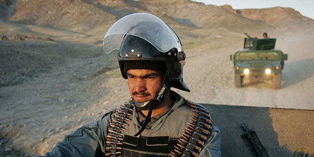 March 19: An Afghan policeman controls the area during a patrol in Guzara district, Herat province east of Kabul, Afghanistan.