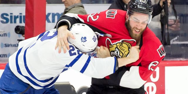 Mar 21, 2015; Ottawa, Ontario, CAN; Toronto Maple Leafs center Zach Sill (22) fights with Ottawa Senators defenseman Eric Gryba (62) in the first period at the Canadian Tire Centre. Mandatory Credit: Marc DesRosiers-USA TODAY Sports